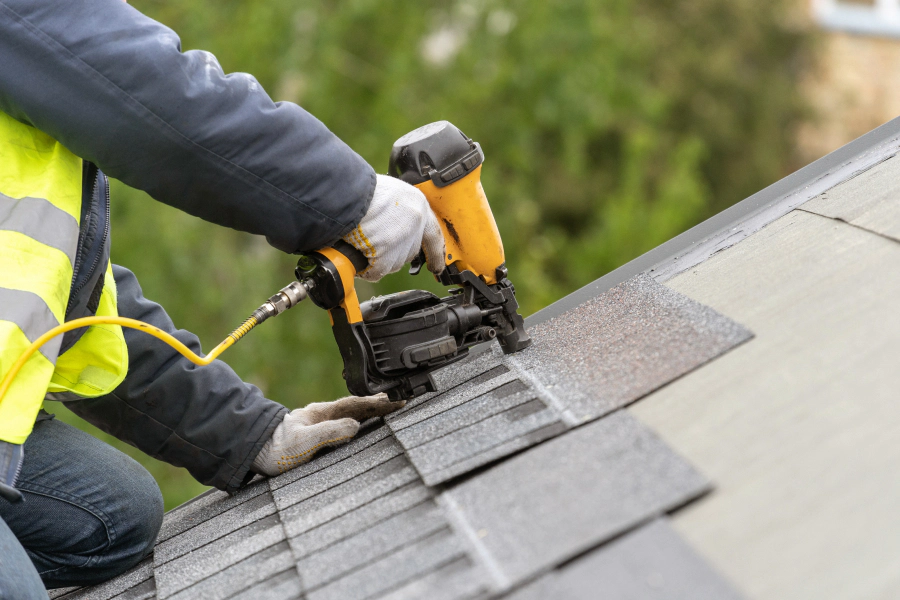 man installing new roof shingles taylor TX